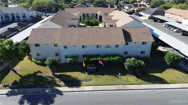 an aerial view of a house with a yard and a outdoor space
