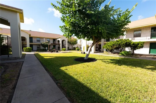 an empty room with windows and ceiling fan