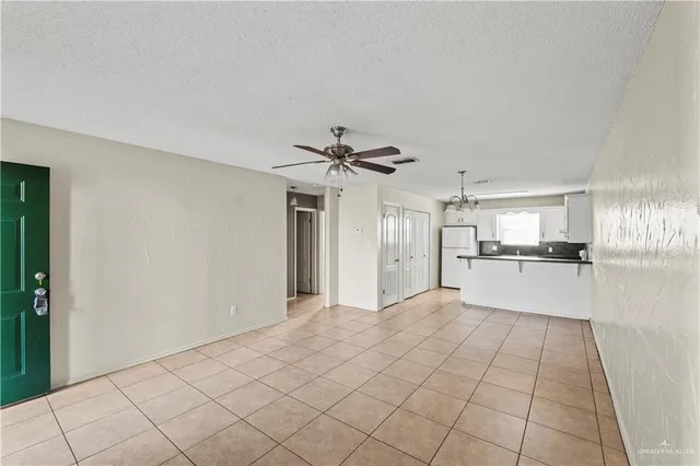 a kitchen that has a stove a sink and dishwasher with white cabinets