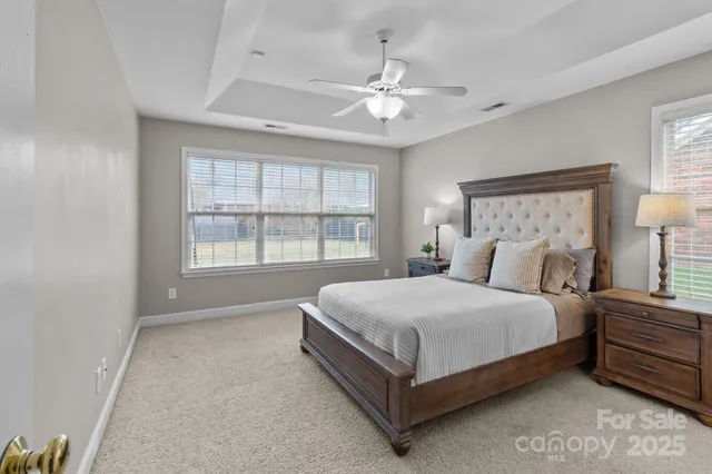 a large bedroom with a bed and window