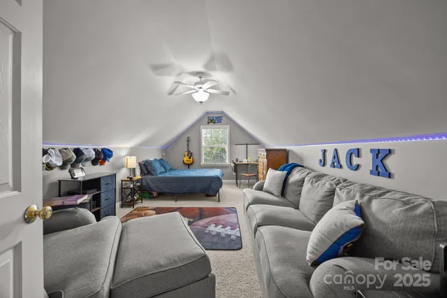 a living room with furniture a rug and a chandelier