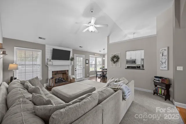 a living room with furniture and a fireplace