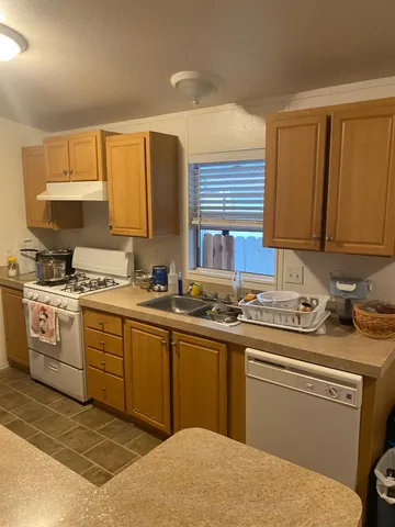 a kitchen with a sink stove and cabinets