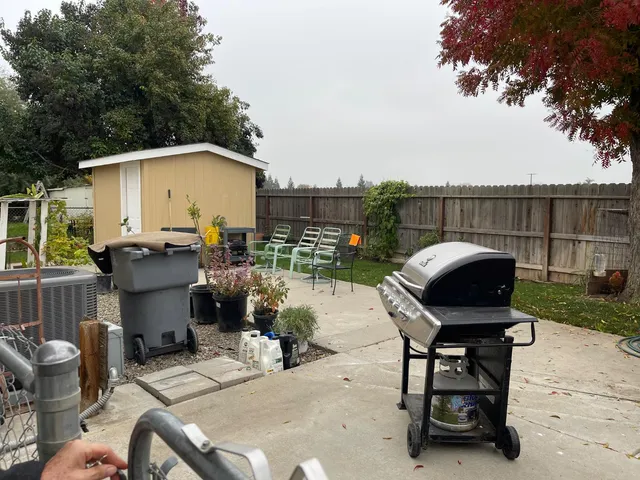 a view of backyard with seating space and trees