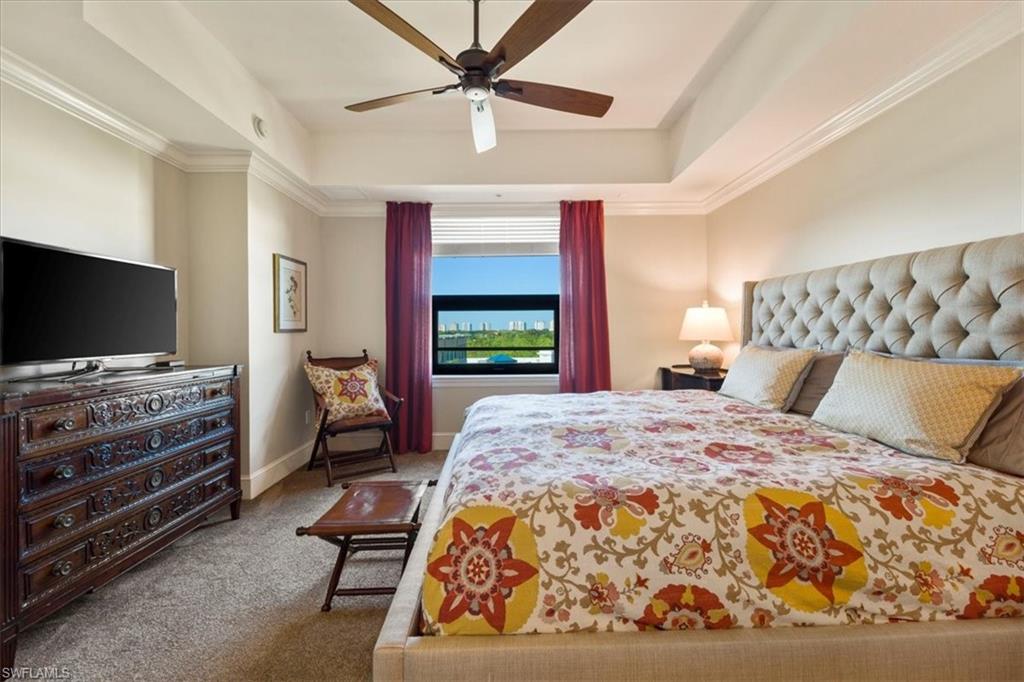 9115 Strada Place, Unit 5512 Naples, FL 34108 - Photo 15 of 42 a bedroom with a bed and a flat screen tv