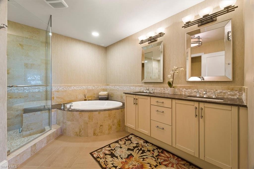 9115 Strada Place, Unit 5512 Naples, FL 34108 - Photo 17 of 42 a spacious bathroom with a granite countertop sink and a mirror