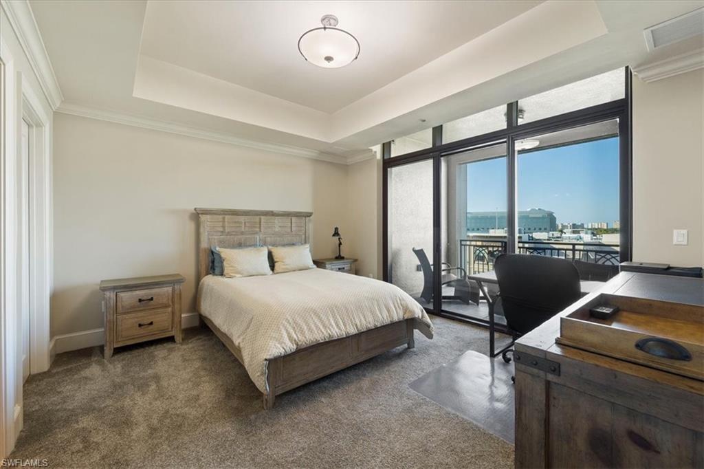 9115 Strada Place, Unit 5512 Naples, FL 34108 - Photo 21 of 42 a bedroom with a bed and large window