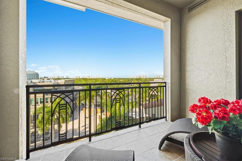 9115 Strada Place, Unit 5512 Naples, FL 34108 - Photo 25 of 42 a balcony with furniture and flowers