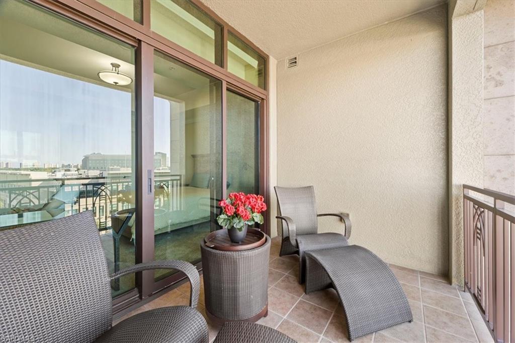 9115 Strada Place, Unit 5512 Naples, FL 34108 - Photo 27 of 42 a balcony with furniture and flowers