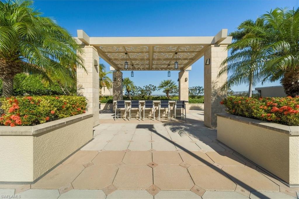 9115 Strada Place, Unit 5512 Naples, FL 34108 - Photo 32 of 42 a view of swimming pool with outdoor seating