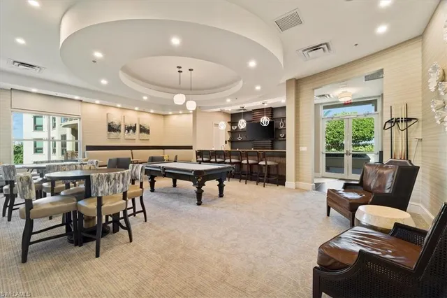 a roof deck with couches and potted plants