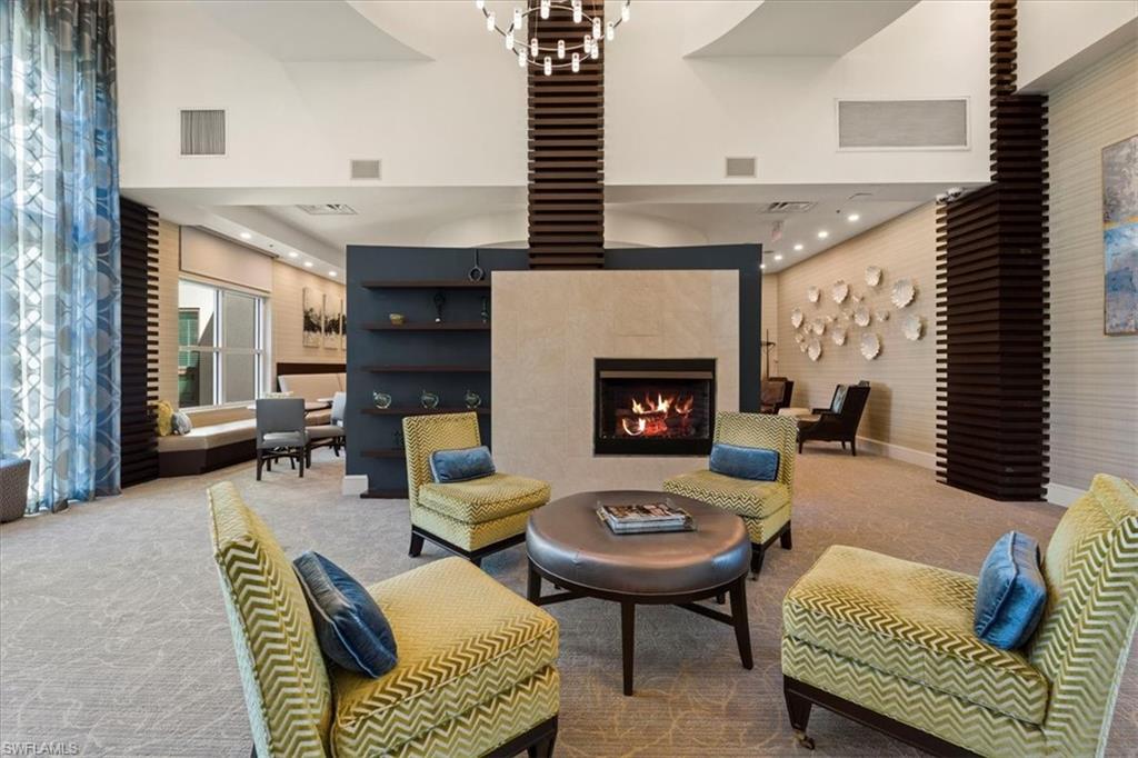 9115 Strada Place, Unit 5512 Naples, FL 34108 - Photo 37 of 42 a living room with furniture and a fireplace