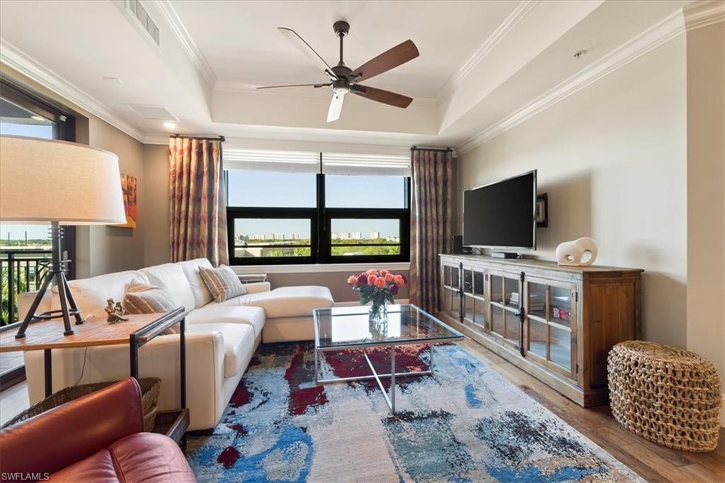 9115 Strada Place, Unit 5512 Naples, FL 34108 - Photo 4 of 42 a living room with furniture and a flat screen tv