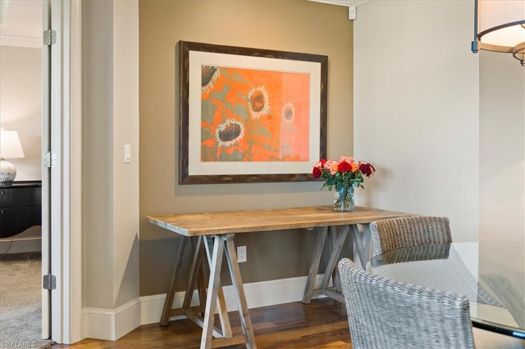 9115 Strada Place, Unit 5512 Naples, FL 34108 - Photo 8 of 42 a dining room with furniture and wooden floor