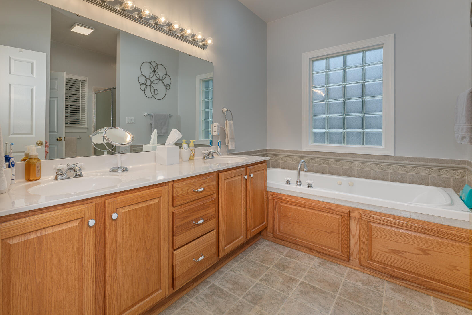 74 Chesney Place Blue Ridge, VA 24064 - Photo 34 of 71 a spacious bathroom with a granite countertop double vanity sink a mirror and a bathtub