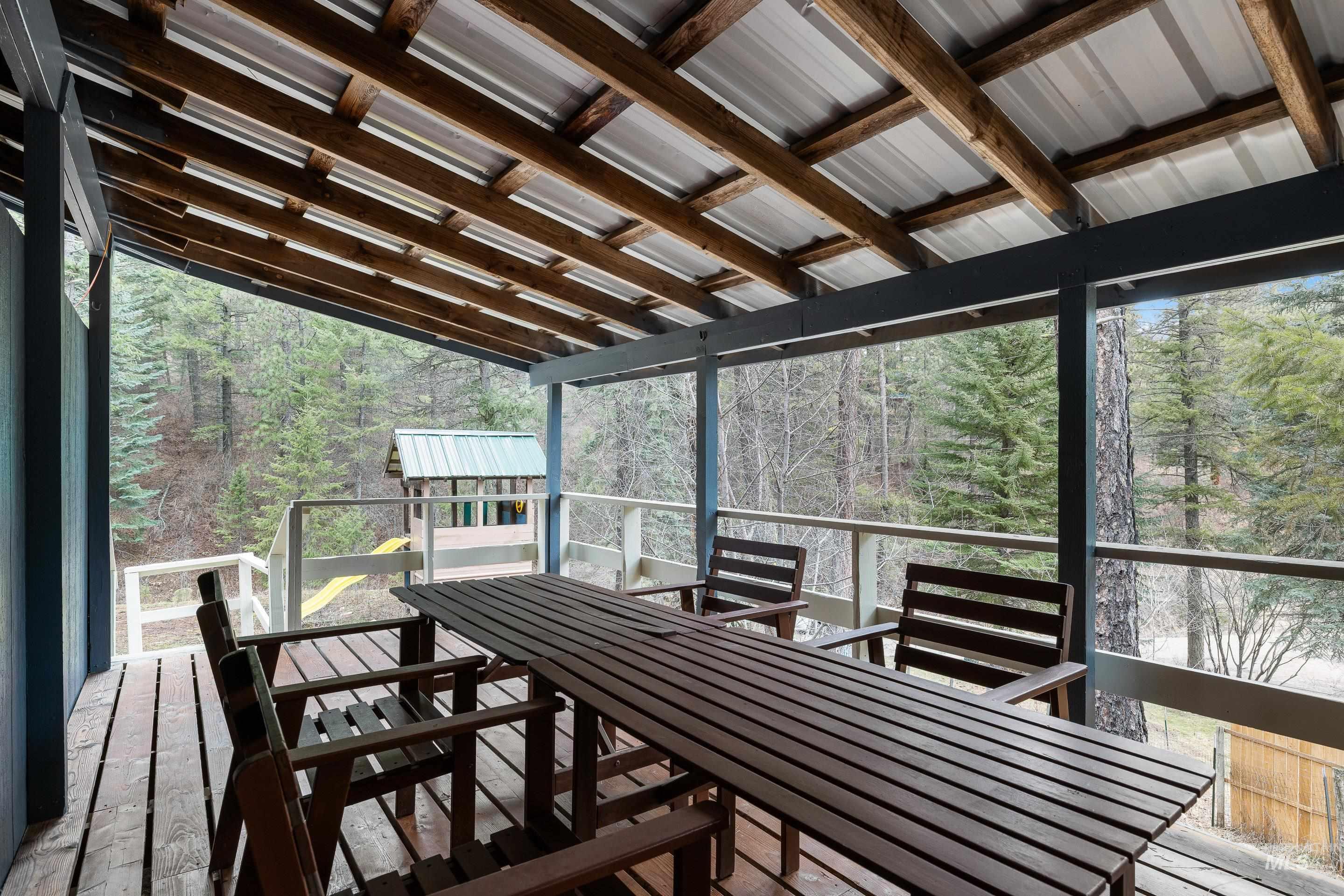 32 Sky Ridge Drive Garden Valley, ID 83622 - Photo 31 of 37 Deck with outdoor dining space and view of wooded area