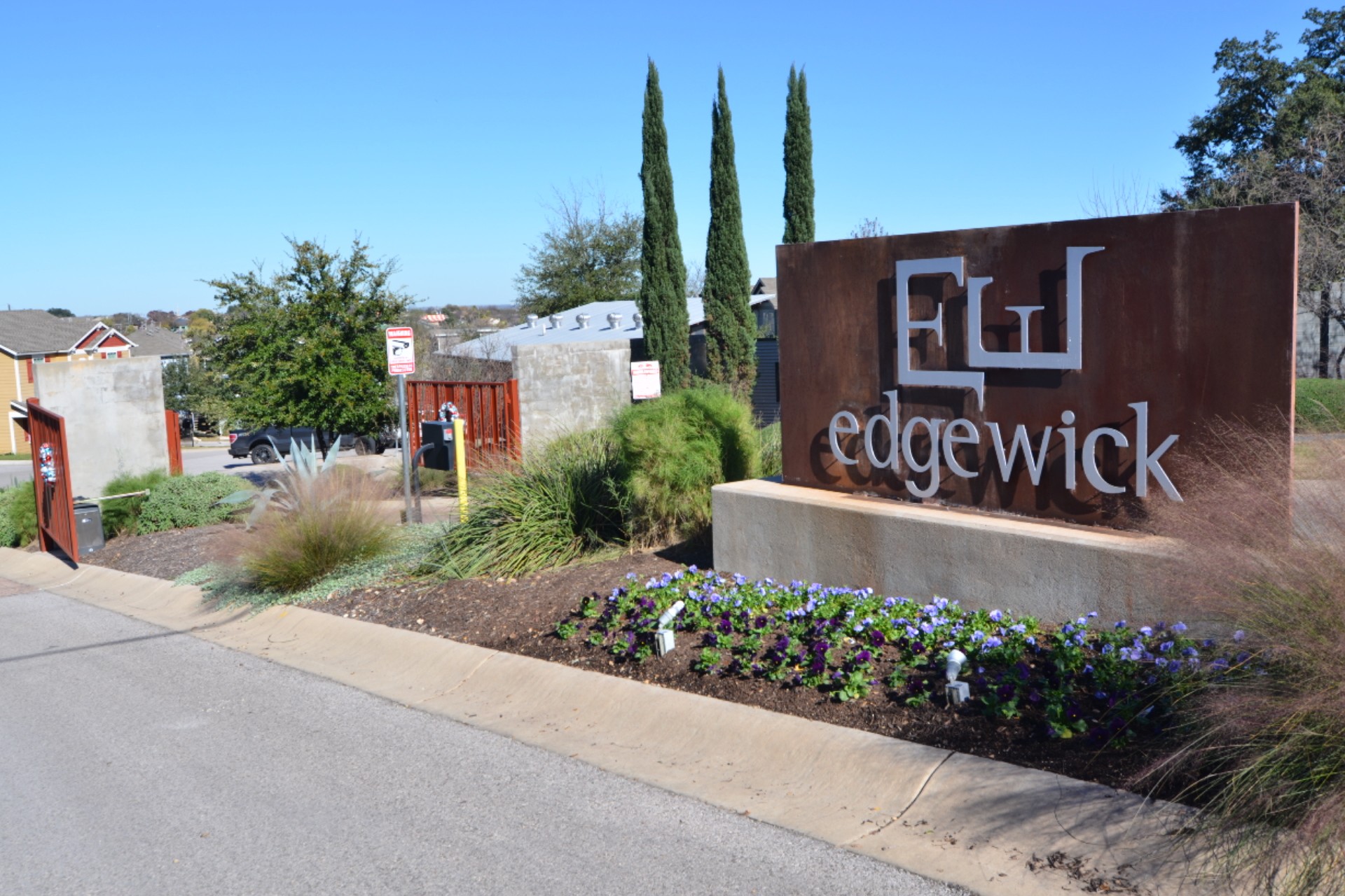 1916 Cleese Drive Austin, TX 78741 - Photo 33 of 36 A welcoming entry sign for Edgewick, framed by vibrant landscaping.