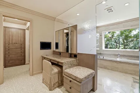 a spacious bathroom with a granite countertop sink and a mirror