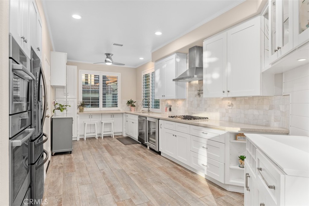 6819 Adolphia Drive Carlsbad, CA 92011 - Photo 21 of 40 a kitchen with stainless steel appliances sink stove refrigerator and cabinets
