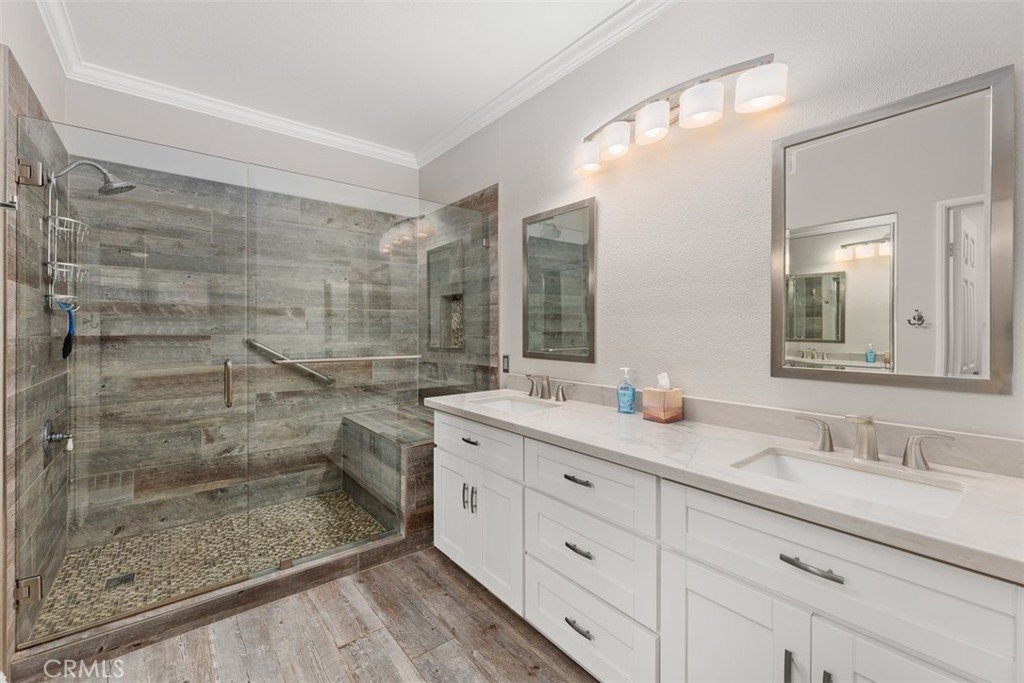 6819 Adolphia Drive Carlsbad, CA 92011 - Photo 29 of 40 a bathroom with a granite countertop sink a mirror and a shower
