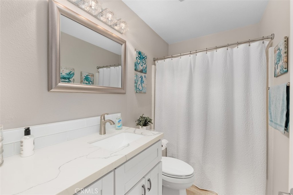 6819 Adolphia Drive Carlsbad, CA 92011 - Photo 36 of 40 a bathroom with a sink a toilet and a mirror