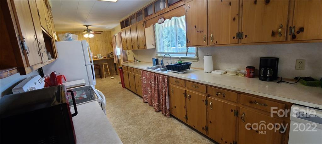 610 Dover Church Road Star, NC 27356 - Photo 8 of 35 a kitchen with granite countertop a sink dishwasher stove and cabinets