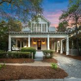 a front view of a house with garden and porch