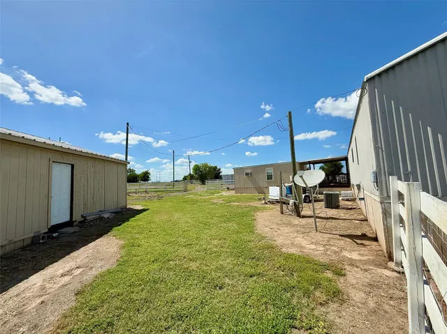 a view of a yard with an outdoor seating
