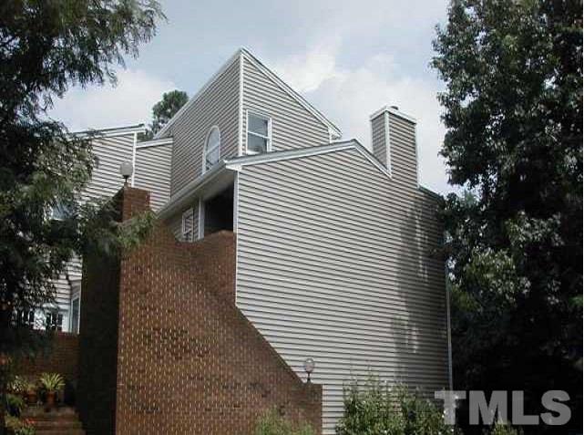 7040 Sandy Forks Road, Unit 207 Raleigh, NC 27615 - Photo 1 of 24 a front view of a house with a tree