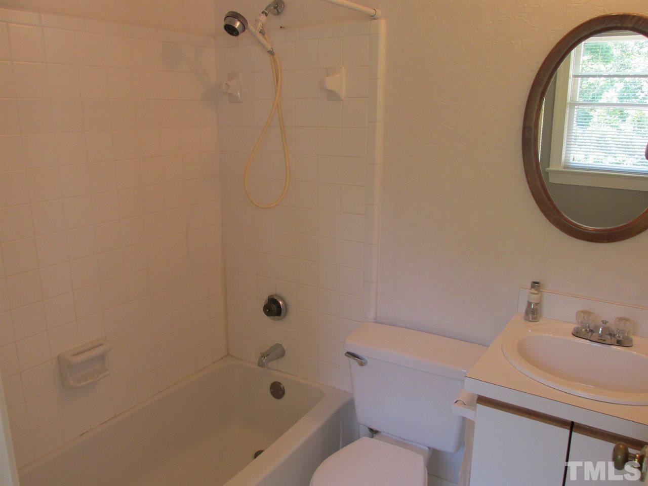 7040 Sandy Forks Road, Unit 207 Raleigh, NC 27615 - Photo 14 of 24 a bathroom with a sink toilet and shower