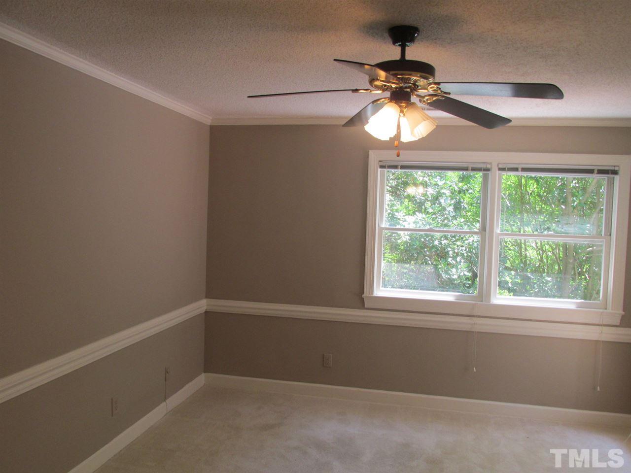 7040 Sandy Forks Road, Unit 207 Raleigh, NC 27615 - Photo 4 of 24 a view of a room with a ceiling fan and a window
