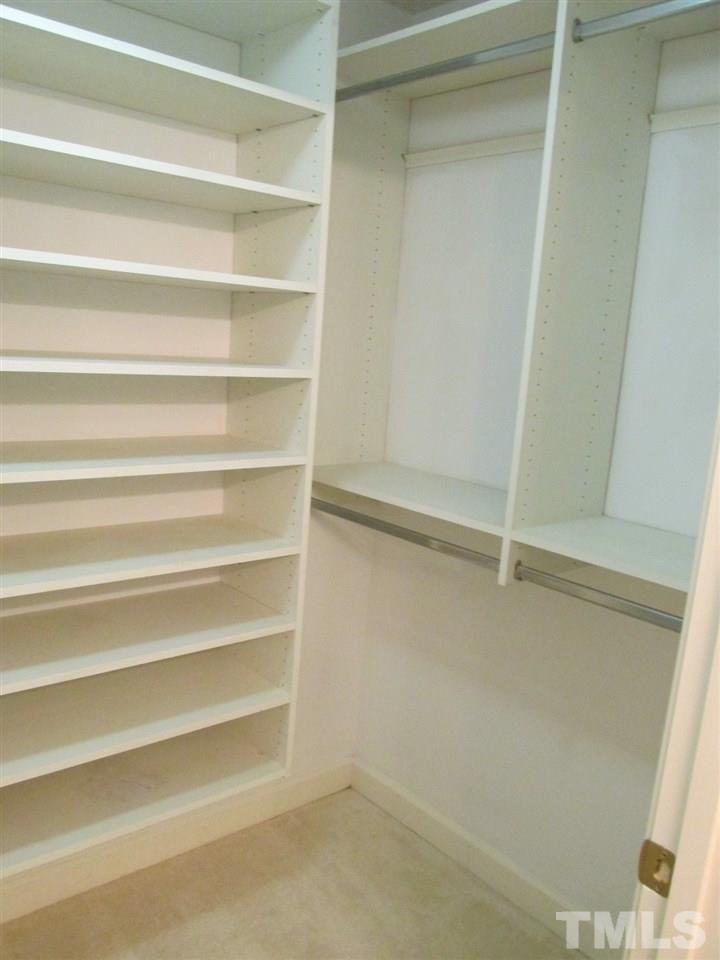 7040 Sandy Forks Road, Unit 207 Raleigh, NC 27615 - Photo 7 of 24 a view of walk in closet with empty racks
