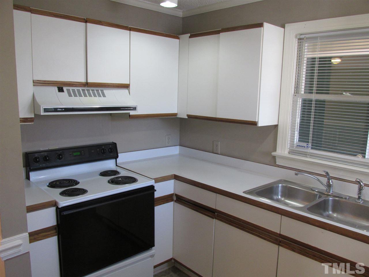 7040 Sandy Forks Road, Unit 207 Raleigh, NC 27615 - Photo 8 of 24 a kitchen with stainless steel appliances a sink stove and cabinets