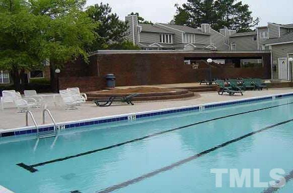 7040 Sandy Forks Road, Unit 207 Raleigh, NC 27615 - Photo 10 of 24 a front view of a house with a yard