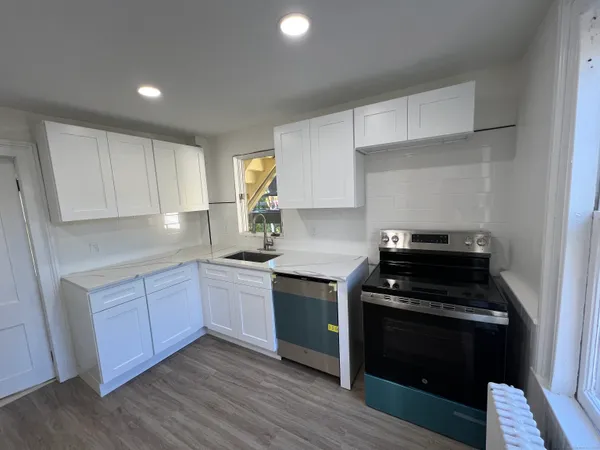 a kitchen with wooden cabinets and a stove top oven