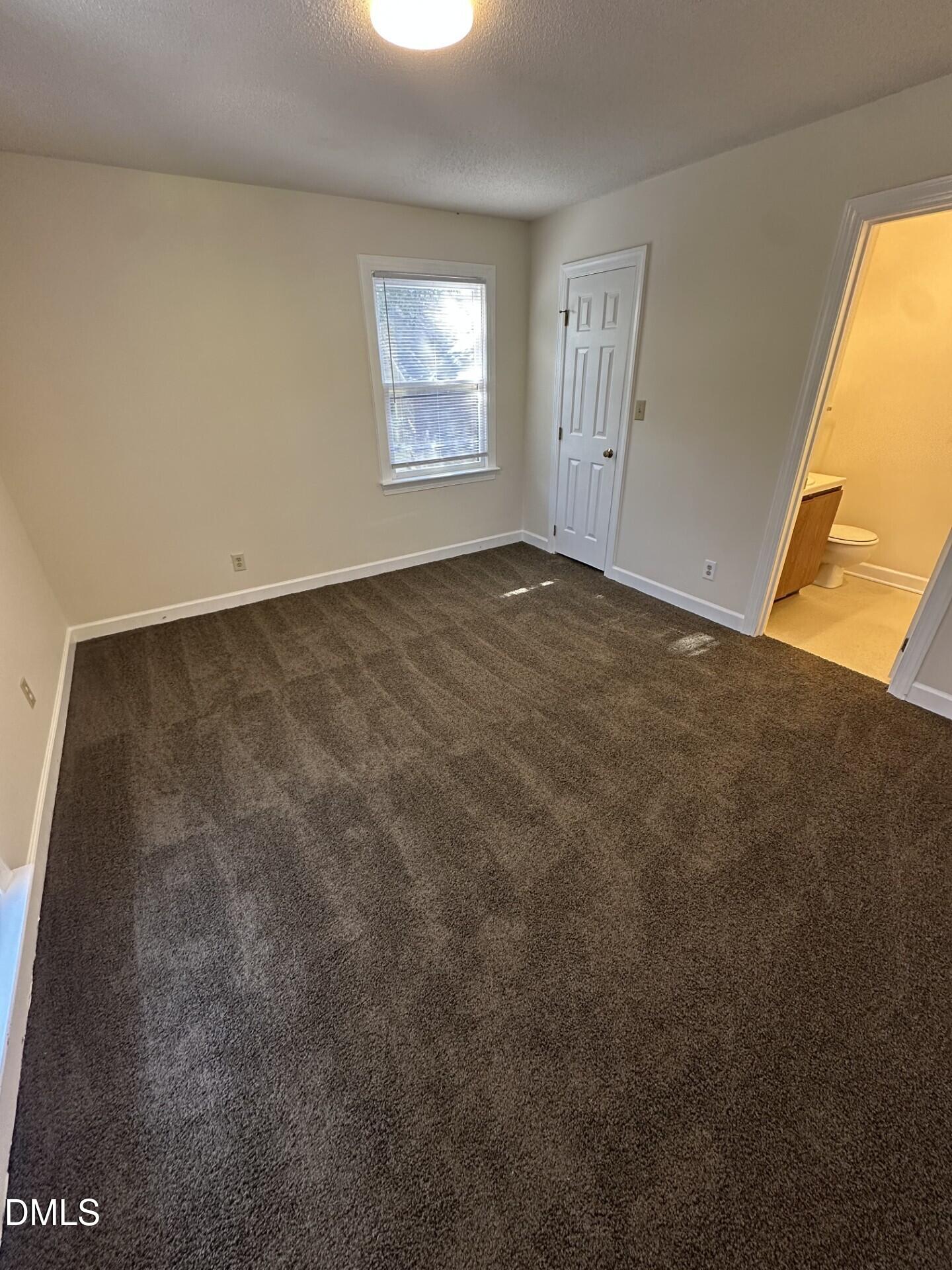 3515 Ivy Commons Drive, Unit 301 Raleigh, NC 27606 - Photo 5 of 6 an empty room with windows