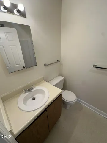 a bathroom with a sink a toilet and mirror