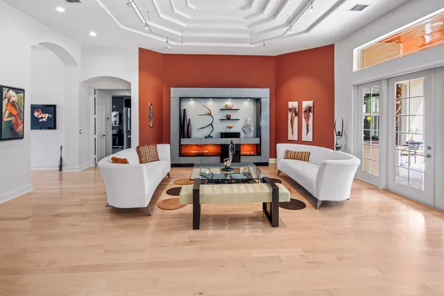 a bedroom with a bed couch and a large window