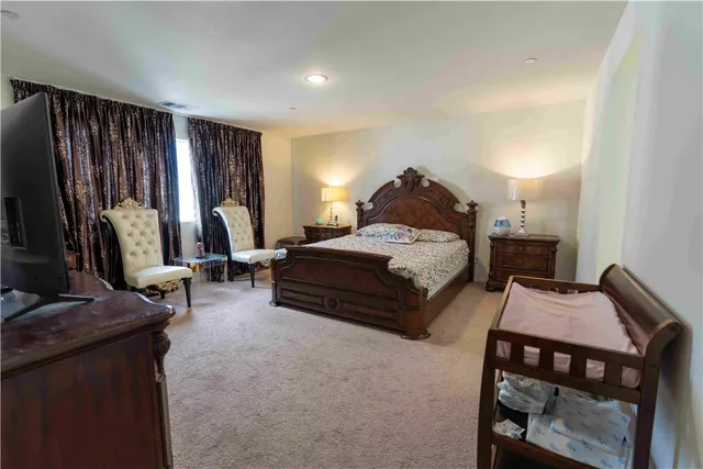 a bedroom with bed and large windows