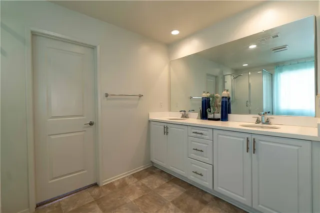 a bathroom with a double vanity sink and mirror