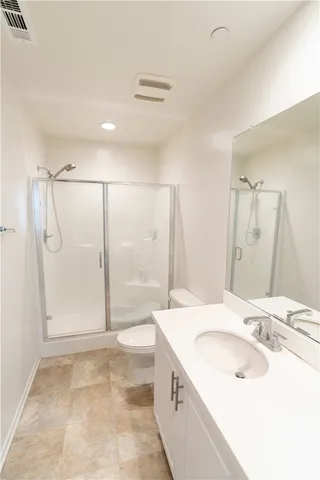 a bedroom with a bed and a chair