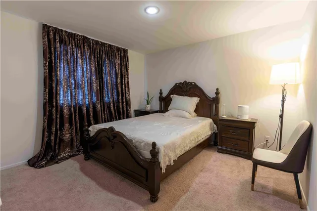 a bed sitting in a bedroom next to a window