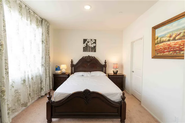 a bedroom with a bed and a window