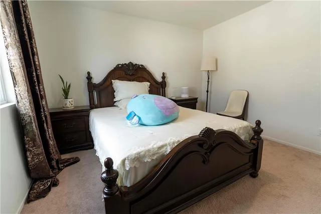 a bedroom with a bed and dresser