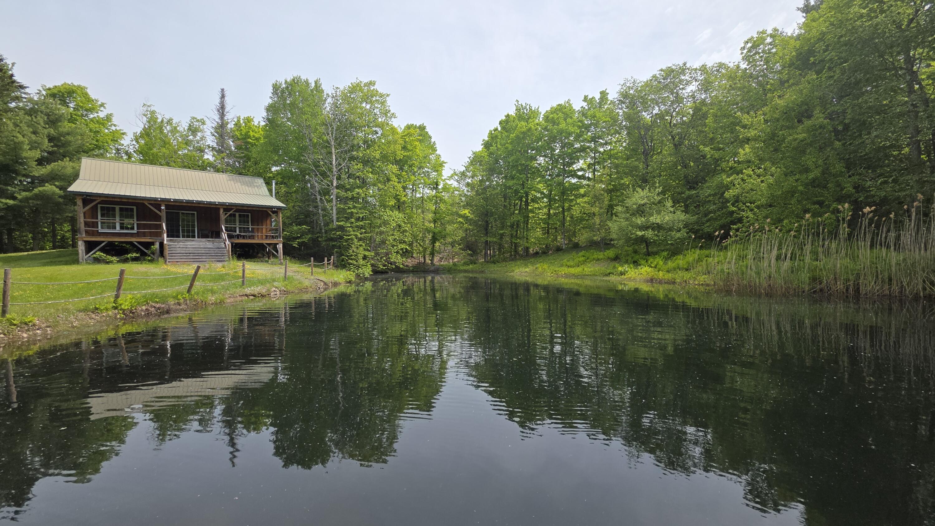 Lot 17 East Thorndike Road Thorndike, ME 04986 - Photo 11 of 31 Front View of Cabin and Pond