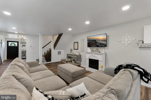 a living room with furniture fireplace and flat screen tv