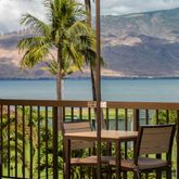 a view of a chair and table in the balcony