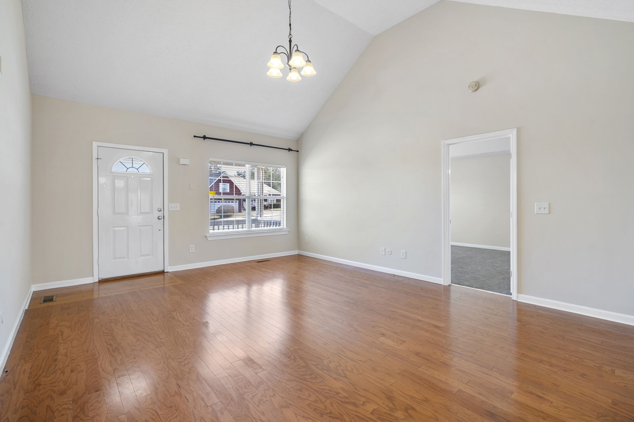 4244 Birmingham Road Lebanon, TN 37090 - Photo 12 of 40 an empty room with wooden floor chandelier and windows