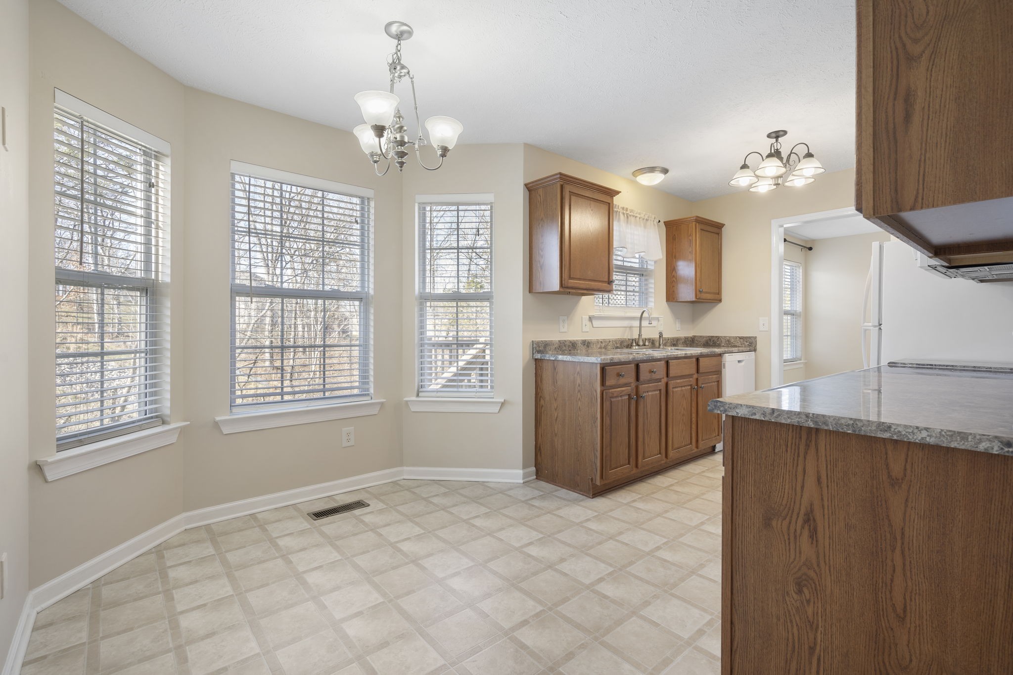 4244 Birmingham Road Lebanon, TN 37090 - Photo 17 of 40 a kitchen with stainless steel appliances granite countertop a sink cabinets a stove and a window