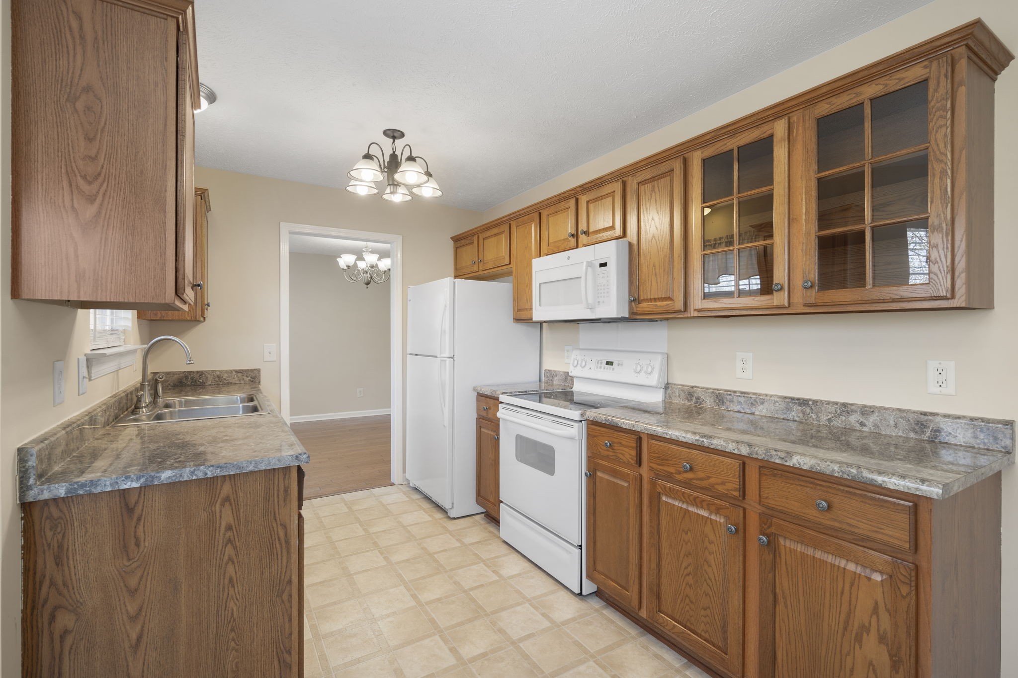 4244 Birmingham Road Lebanon, TN 37090 - Photo 19 of 40 a kitchen with stainless steel appliances granite countertop a sink dishwasher stove and refrigerator with wooden floor